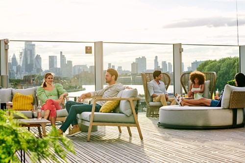 People Sitting Outside On A Roof Terrace
